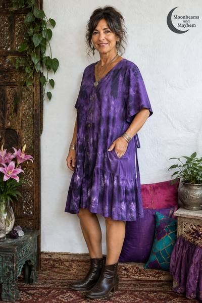 Three-quarter view of the Violet Moon tunic dress showing the side pocket and flutter sleeve