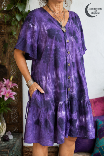 Close-up of the Violet Moon tunic dress showing the V-neckline, brown buttons and tie-dye cotton