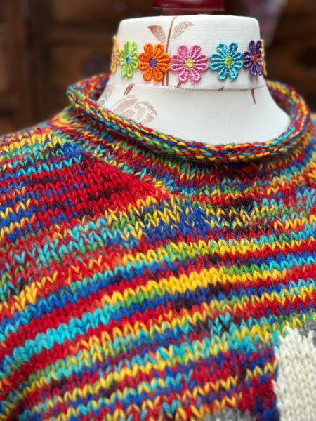 Close-up of the softly rolled neckline and multicoloured wool stitches on the Wild Daisy jumper