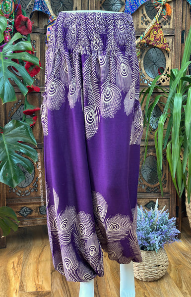 Full-length front view of purple peacock feather harem trousers on a mannequin