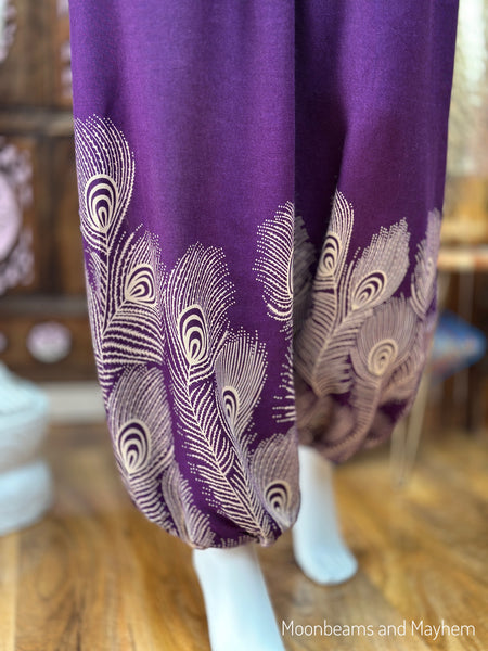 Close-up of the gathered ankles and cream peacock feather border print