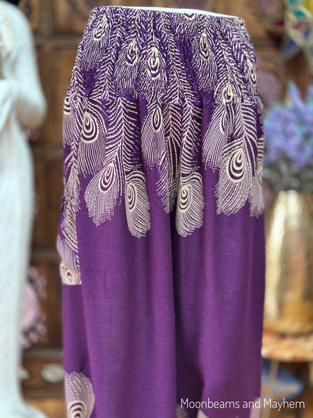 Close-up of the elasticated waistband, side pocket and peacock feather print